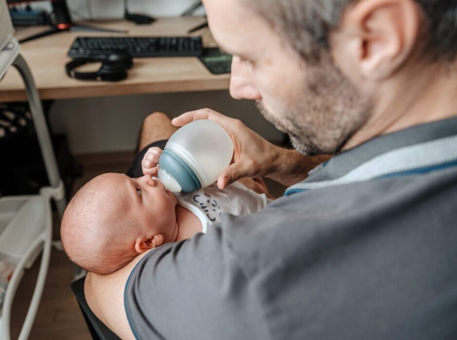 Dad feeding a bottle to his baby